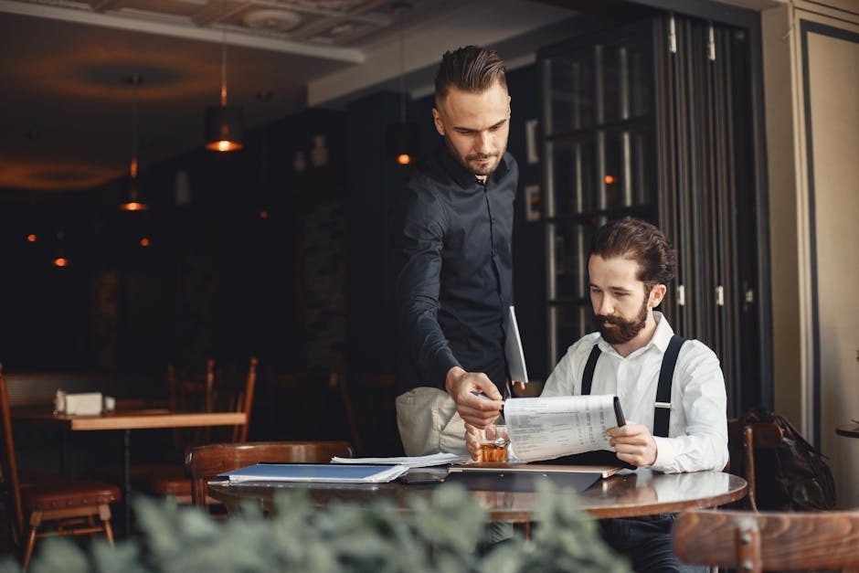 A hospitality operator reviewing the menu and supplier list in a restaurant office